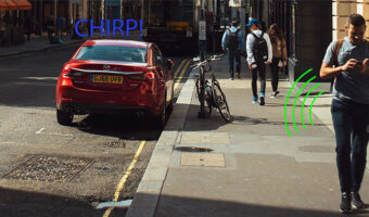 A man using his smartphone to connect to his vehicle and his vehicle responding with a chirp