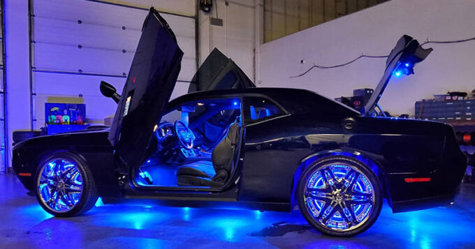 A car with a lighting upgrade shining out of all of the open doors