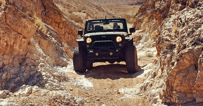 A jeep going off-road on a canyon