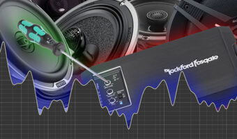 An assortment of car audio equipment and a screwdriver