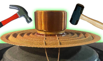 A hammer and a mallet one on each side of the inside of a car audio speaker sound coil
