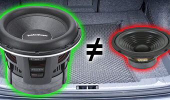 Two glowing subwoofers in a trunk