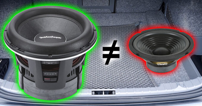 Two glowing subwoofers in a trunk